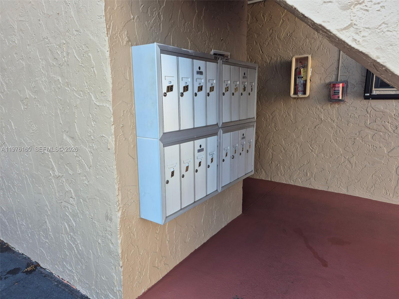 A wall-mounted cluster of metal mailboxes is located under an outdoor staircase — 1185 W 27th St, Hialeah FL 33010, HIALEAH, FL