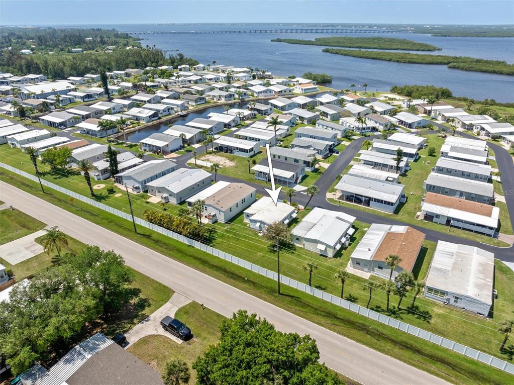 An aerial view shows a manufactured home community located near a body of water — 4300 RIVERSIDE DRIVE UNIT 14, PUNTA GORDA, FL