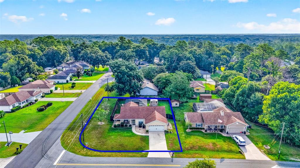 An aerial view shows a single-story suburban house with a blue outline on its lot — 1 TEAK COURT, OCALA, FL