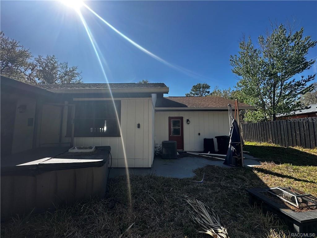 The exterior of a house features a patio, a hot tub, and a red door — 4197 N CONCORD DRIVE, CRYSTAL RIVER, FL
