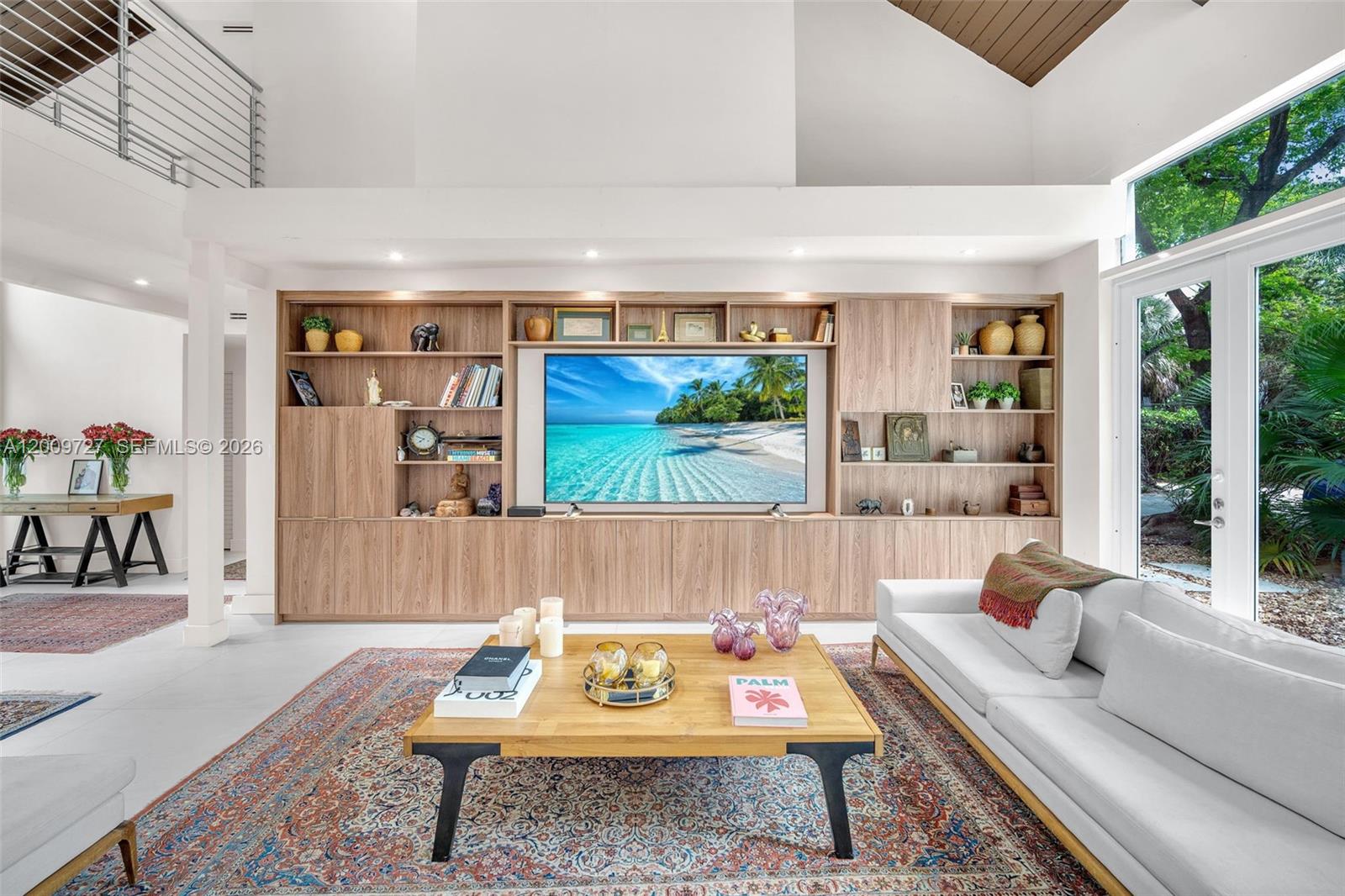 A living room features a large built-in wooden media wall, a coffee table, and a sofa — 1933 S Oak Haven Cir, Miami FL 33179, MIAMI, FL