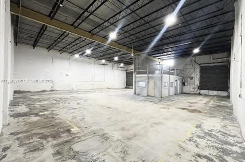 An empty industrial warehouse space with a concrete floor, high ceilings, and an office enclosure — 4201 NW 37th Ct # 4239, Hialeah FL 33142, HIALEAH, FL