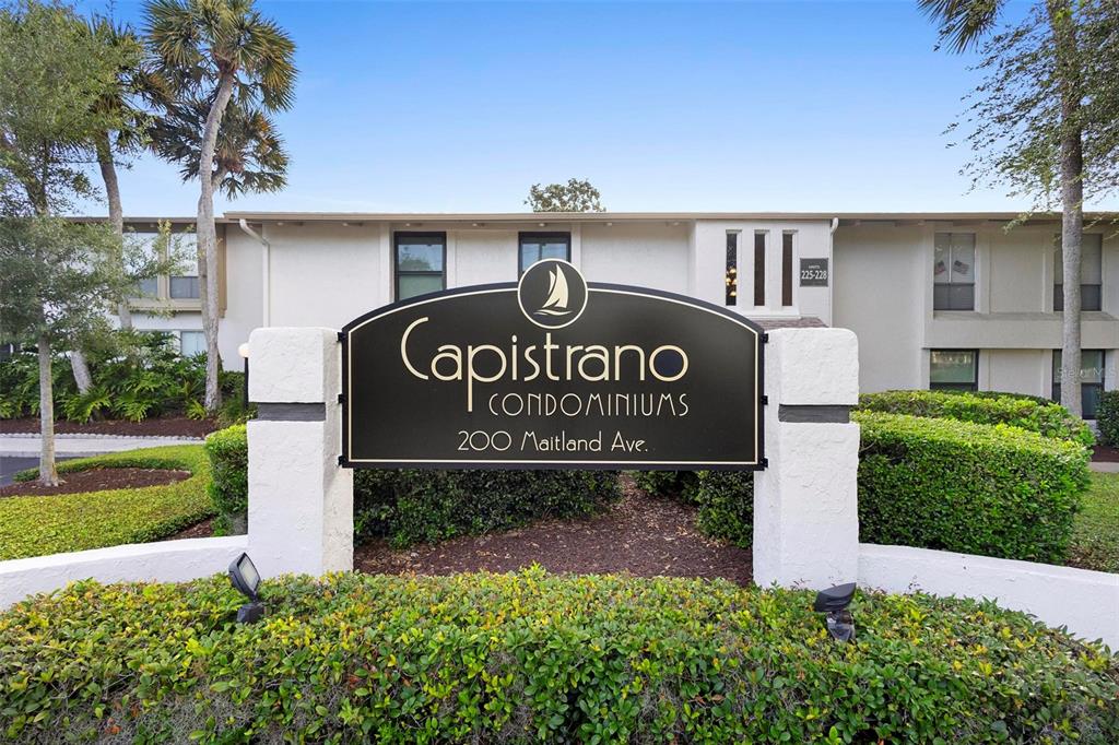A black sign for Capistrano Condominiums stands in front of a two-story apartment building — 200 MAITLAND AVENUE UNIT 174, ALTAMONTE SPRINGS, FL