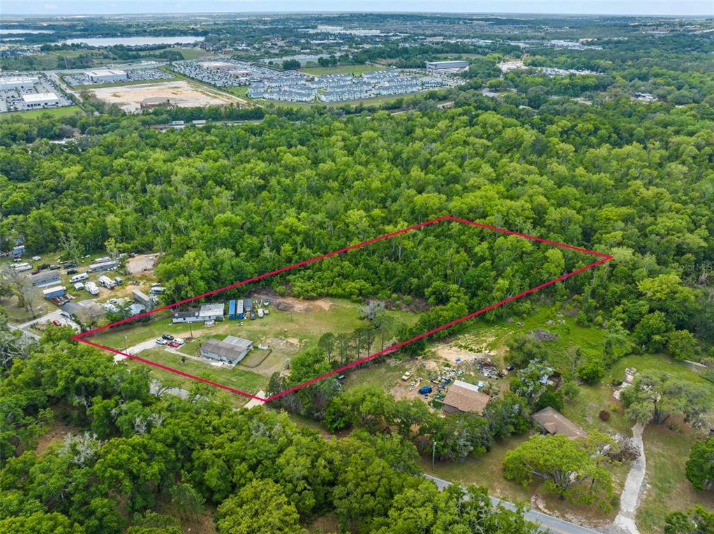 An aerial view shows a rectangular property outlined in red containing two houses and trees — 16838 OLD HIGHWAY 50, WINTER GARDEN, FL