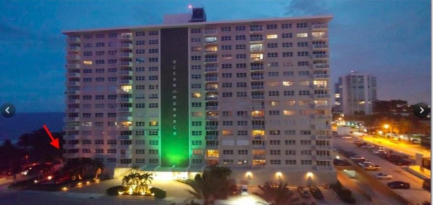 An exterior view of the Ocean Monarch high-rise apartment building at dusk — 133 N Pompano Beach Boulevard # 210, Pompano Beach FL 33062, POMPANO BEACH, FL