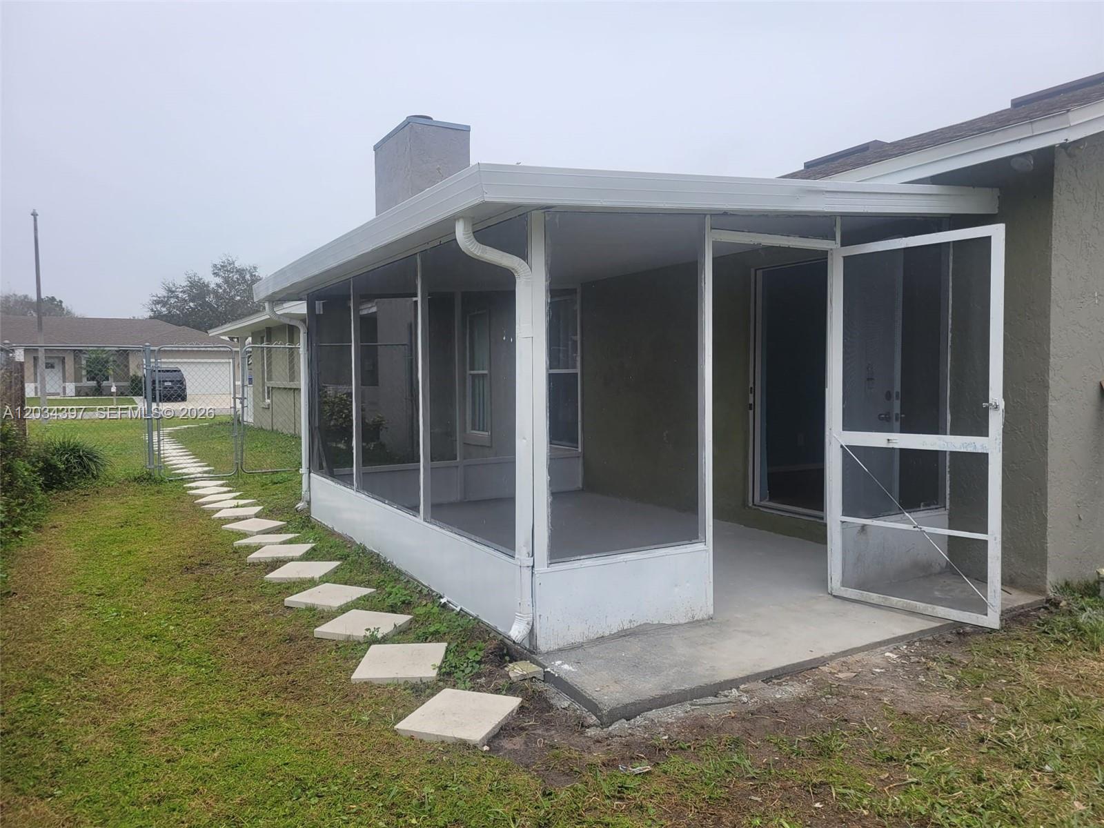 A screened-in patio with a concrete floor and white aluminum framing attached to a house — 20420 Marlin st # B, Orlando FL 32833, ORLANDO, FL