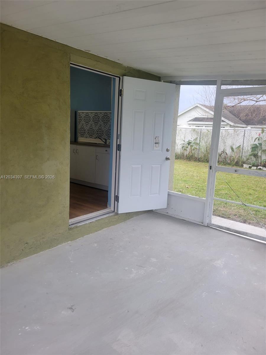 A covered porch with a concrete floor leads into a kitchen through an open door — 20420 Marlin st # B, Orlando FL 32833, ORLANDO, FL