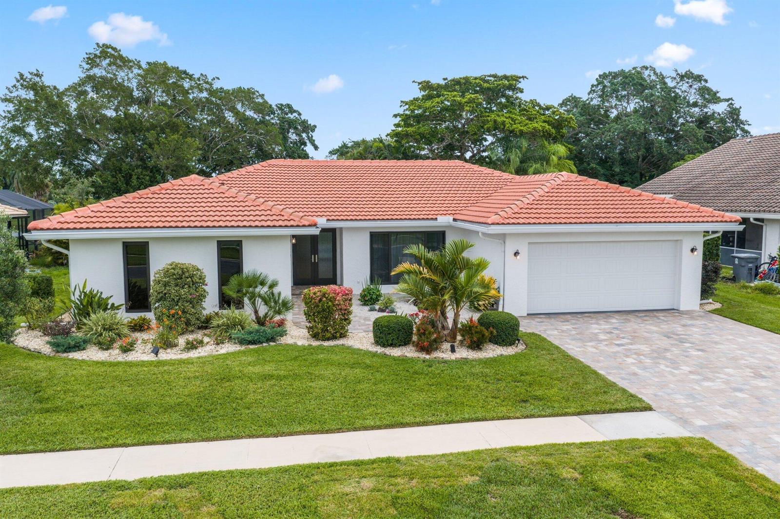 A single-story house with a white exterior, red tile roof, and a paved driveway — 20195 Back 9 Drive, Boca Raton FL 33498, BOCA RATON, FL