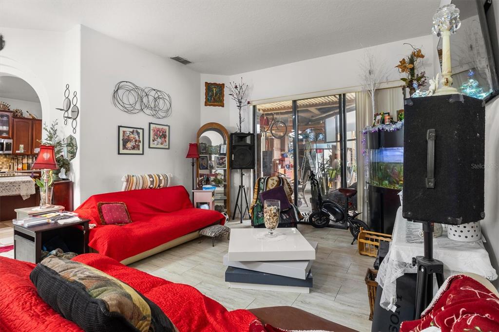 A living room features red sofas, a white coffee table, and a large fish tank — 428 COVENTRY ROAD, DAVENPORT, FL
