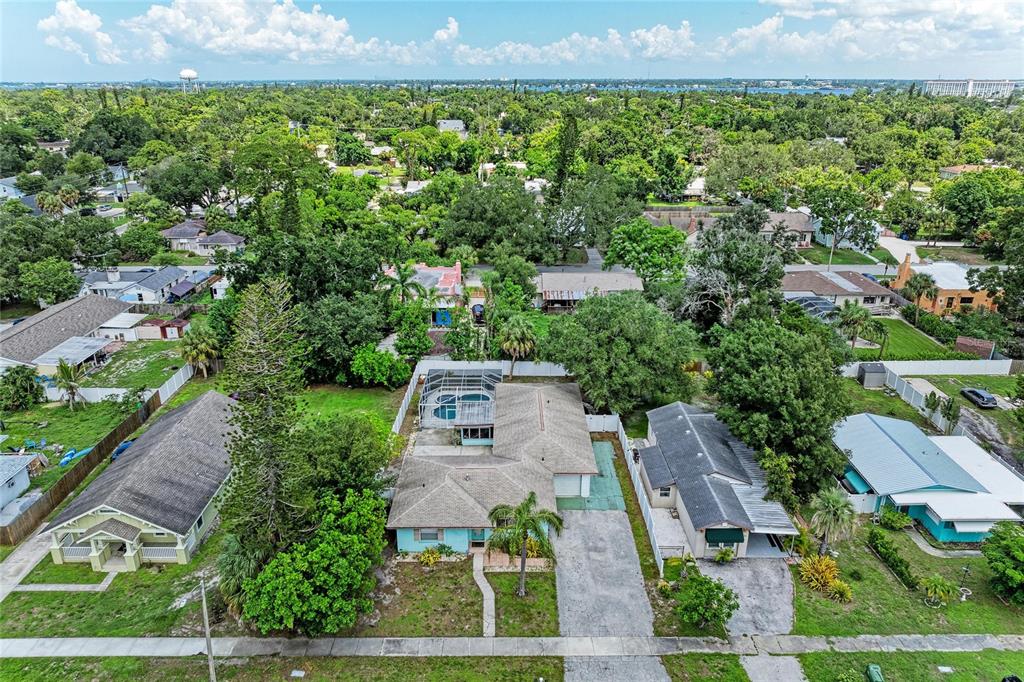 An aerial view shows a residential neighborhood with a light blue house featuring a pool — 2508 14TH AVENUE W, BRADENTON, FL