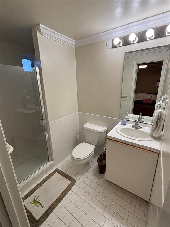 A tiled balcony features a white door, a small window, and potted plants — 4950 BAYSHORE BOULEVARD UNIT 28, TAMPA, FL