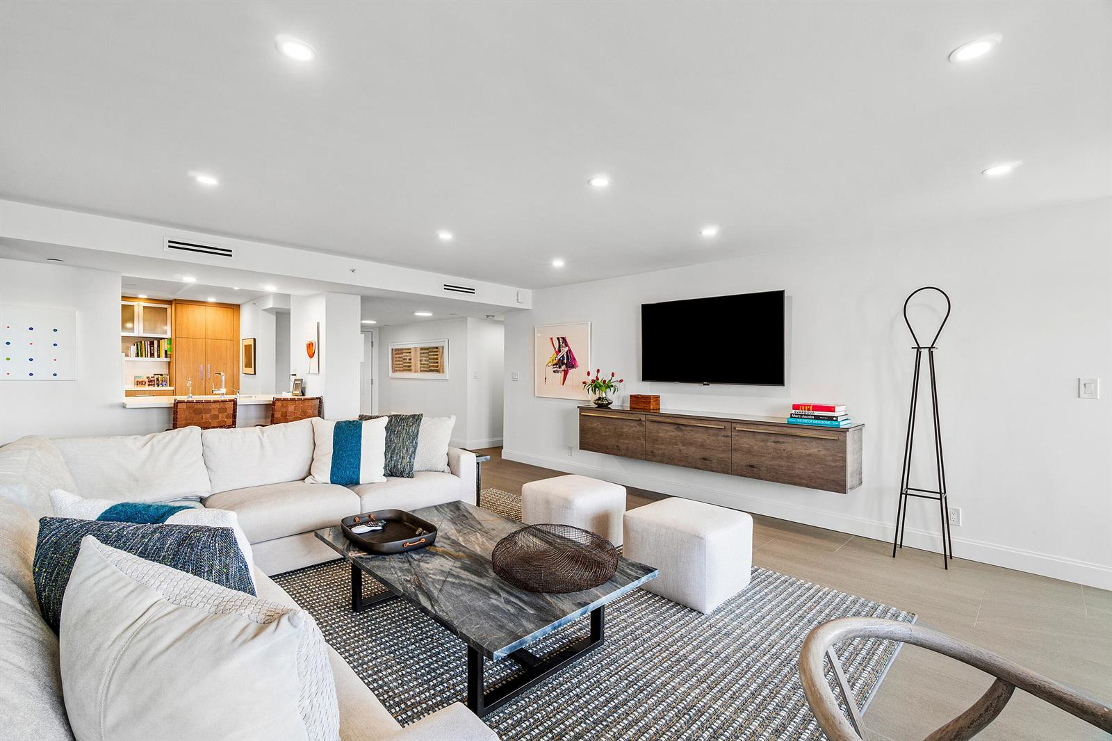 A modern living room features a white sectional sofa, marble coffee table, and wall-mounted media console — 3420 S Ocean Boulevard # 14x, Highland Beach FL 33487, HIGHLAND BEACH, FL