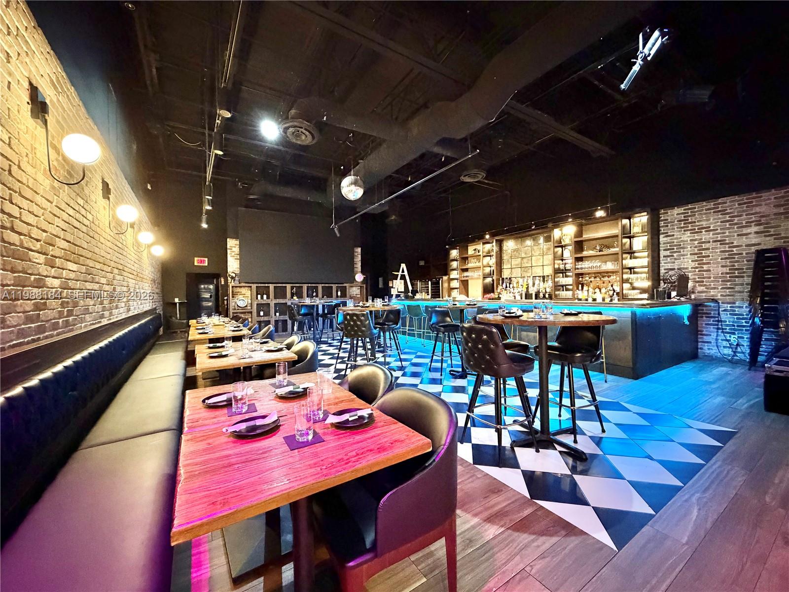 A restaurant interior features green tufted booths, wooden tables, and a black-and-white checkered floor — 4273 NW 41ST ST, Doral FL 33178, DORAL, FL