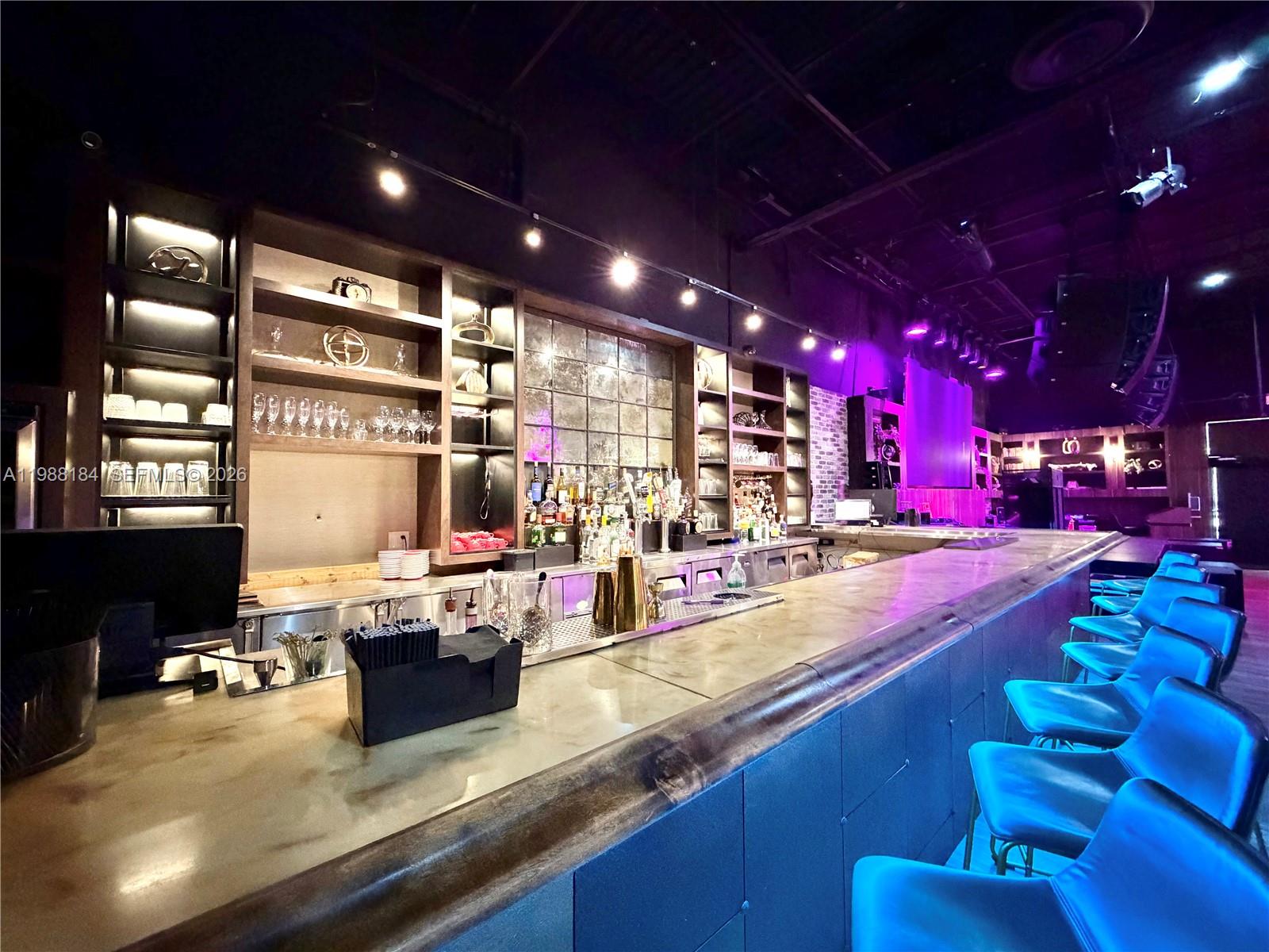 A restaurant interior features brick walls, wooden ceiling beams, booth seating, and pendant lighting — 4273 NW 41ST ST, Doral FL 33178, DORAL, FL