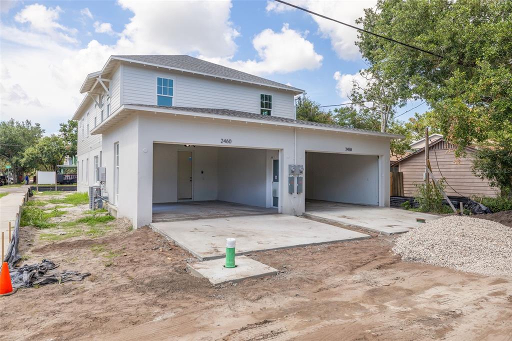 A two-story house with an open-air two-car garage and unfinished dirt ground — 2460 1ST AVENUE S, ST PETERSBURG, FL