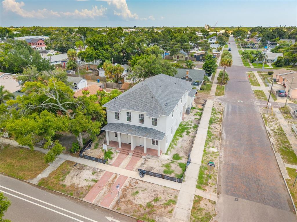 An aerial view of a newly constructed two-story duplex on a corner lot — 2460 1ST AVENUE S, ST PETERSBURG, FL