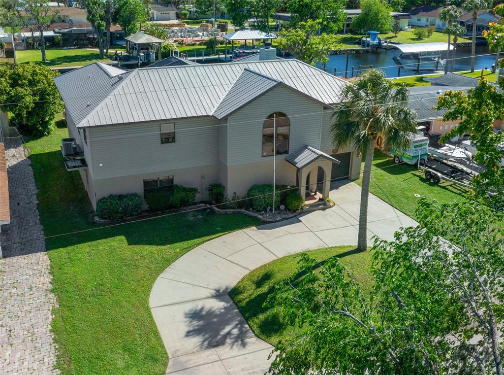 An aerial view of a two-story house with a metal roof and a concrete driveway — 2050 NW 18TH STREET, CRYSTAL RIVER, FL