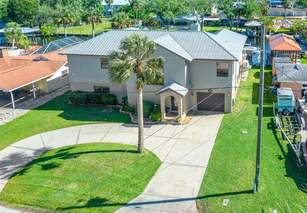 An aerial view of a two-story house with a metal roof and a concrete driveway — 2050 NW 18TH STREET, CRYSTAL RIVER, FL