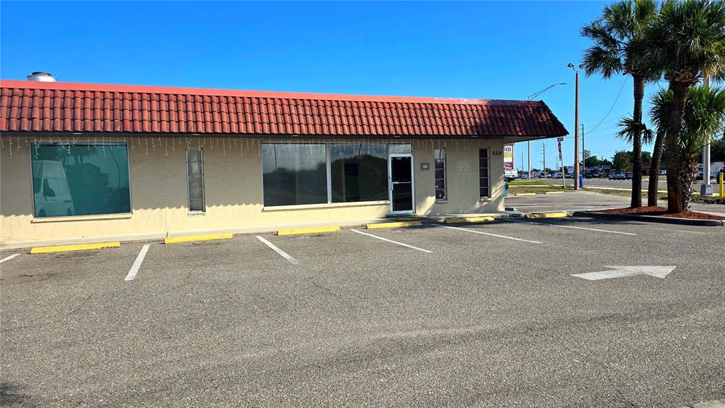 A single-story commercial building with a red tile roof and a paved parking lot — 530 US-41-BYP UNIT 1A, VENICE, FL