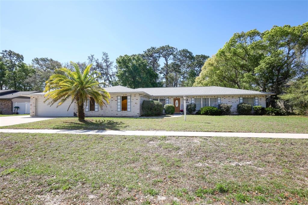 An aerial view shows a single-story house with a screened pool and a front lawn — 504 RIDGEWOOD STREET, ALTAMONTE SPRINGS, FL