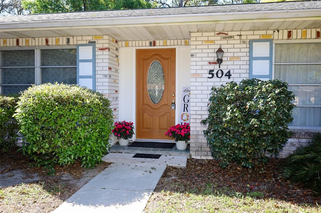 A single-story brick house with a palm tree and a large front lawn — 504 RIDGEWOOD STREET, ALTAMONTE SPRINGS, FL