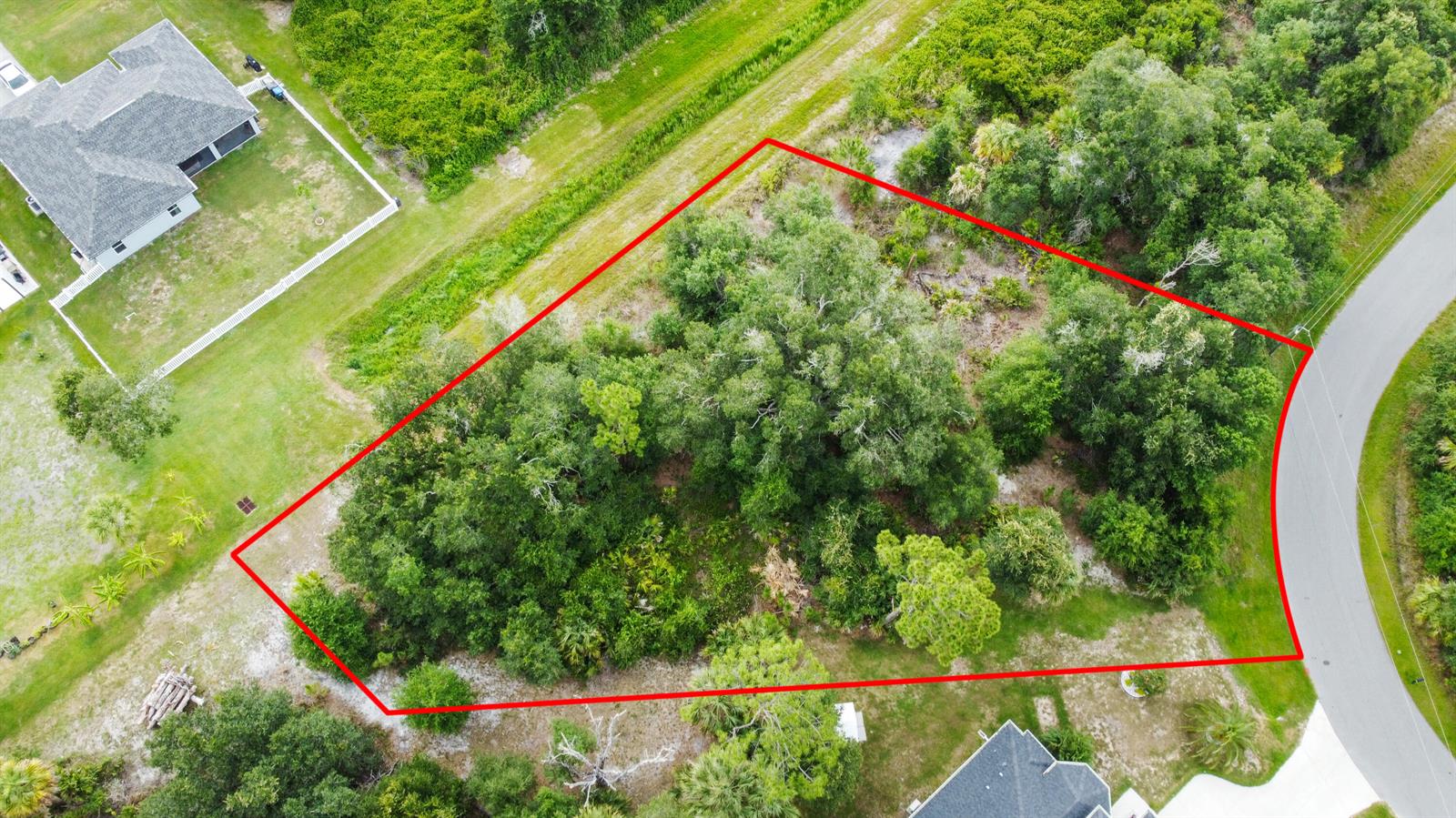 An aerial view shows a wooded, irregularly shaped vacant lot outlined in red — Ancient Ancient, North Port FL 34286, NORTH PORT, FL
