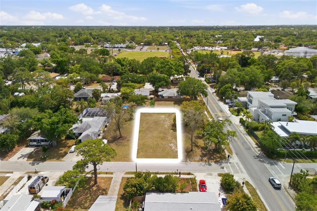 An aerial view shows a vacant, rectangular residential lot situated between houses and a road — 0 BAY STREET, SARASOTA, FL