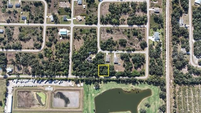 This aerial map shows a vacant lot highlighted in yellow within a residential neighborhood — 29359 NOTTINGHAM ROAD, PUNTA GORDA, FL