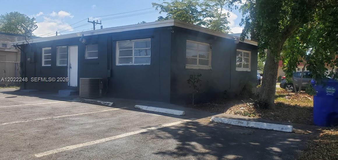A single-story commercial building with black exterior walls and a parking lot in front — 6151 Washington St, Hollywood FL 33023, HOLLYWOOD, FL