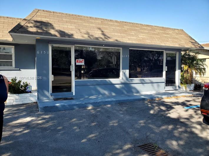 A single-story commercial building with a blue exterior and large glass windows — 6151 Washington St, Hollywood FL 33023, HOLLYWOOD, FL