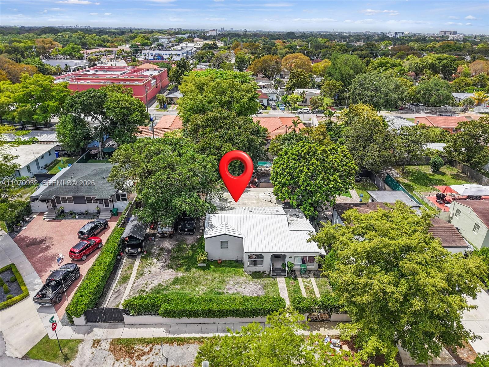An aerial view shows a single-story house with a metal roof and a large yard — 700 SW 44th Pl, Miami FL 33134, MIAMI, FL