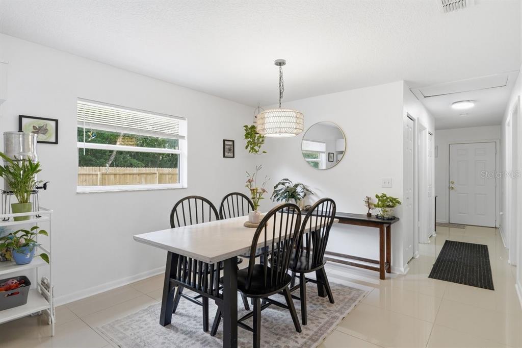 A dining room features a table with black spindle chairs, a pendant light, and tile flooring — 950 S PARSONS AVENUE, DELAND, FL