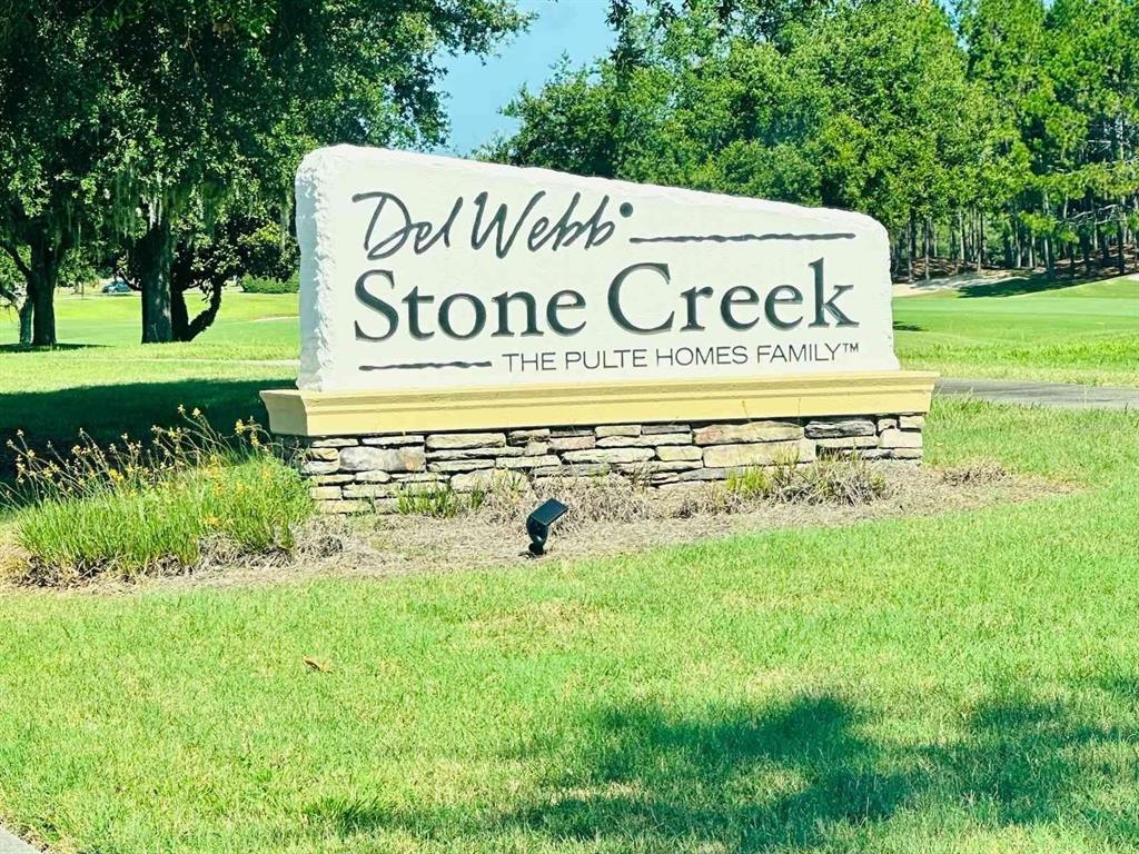 A stone monument sign for Del Webb Stone Creek sits on a grassy lawn — 9335 SW 53RD PLACE, OCALA, FL