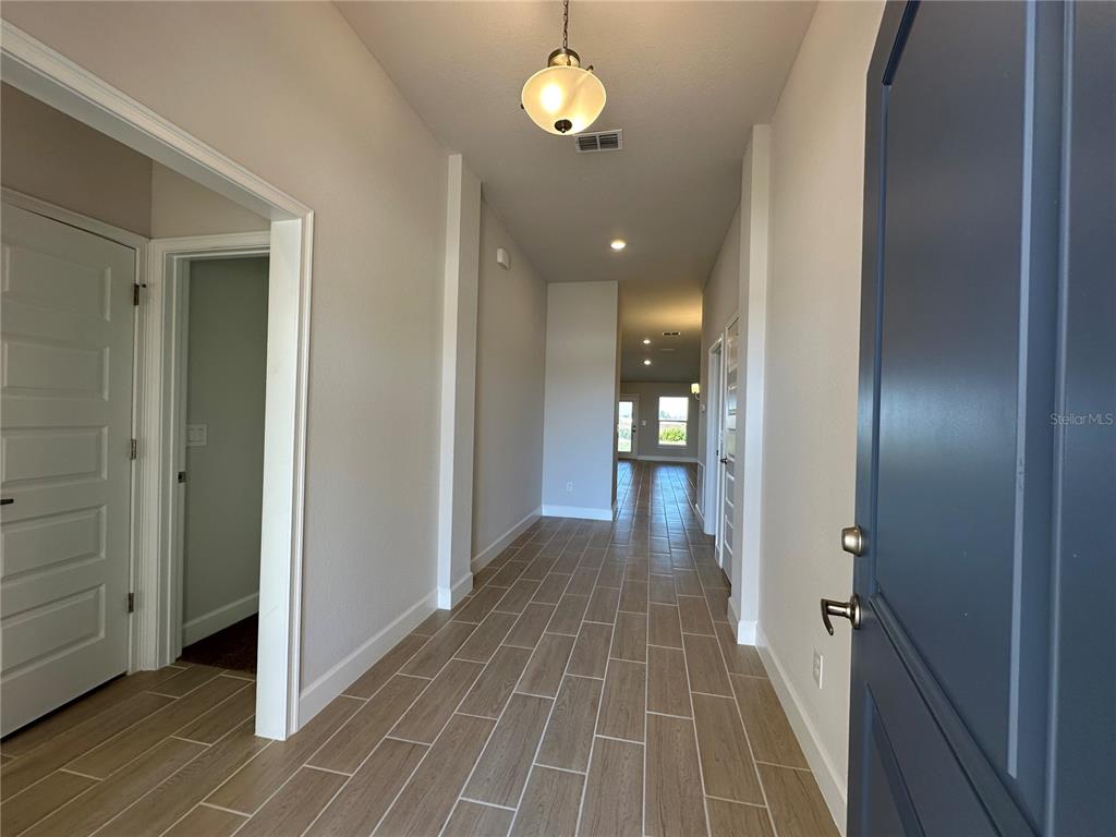 An unfinished room with drywall, a kitchen island base, and a view of a field — 12535 NE 48TH TERRACE, OXFORD, FL