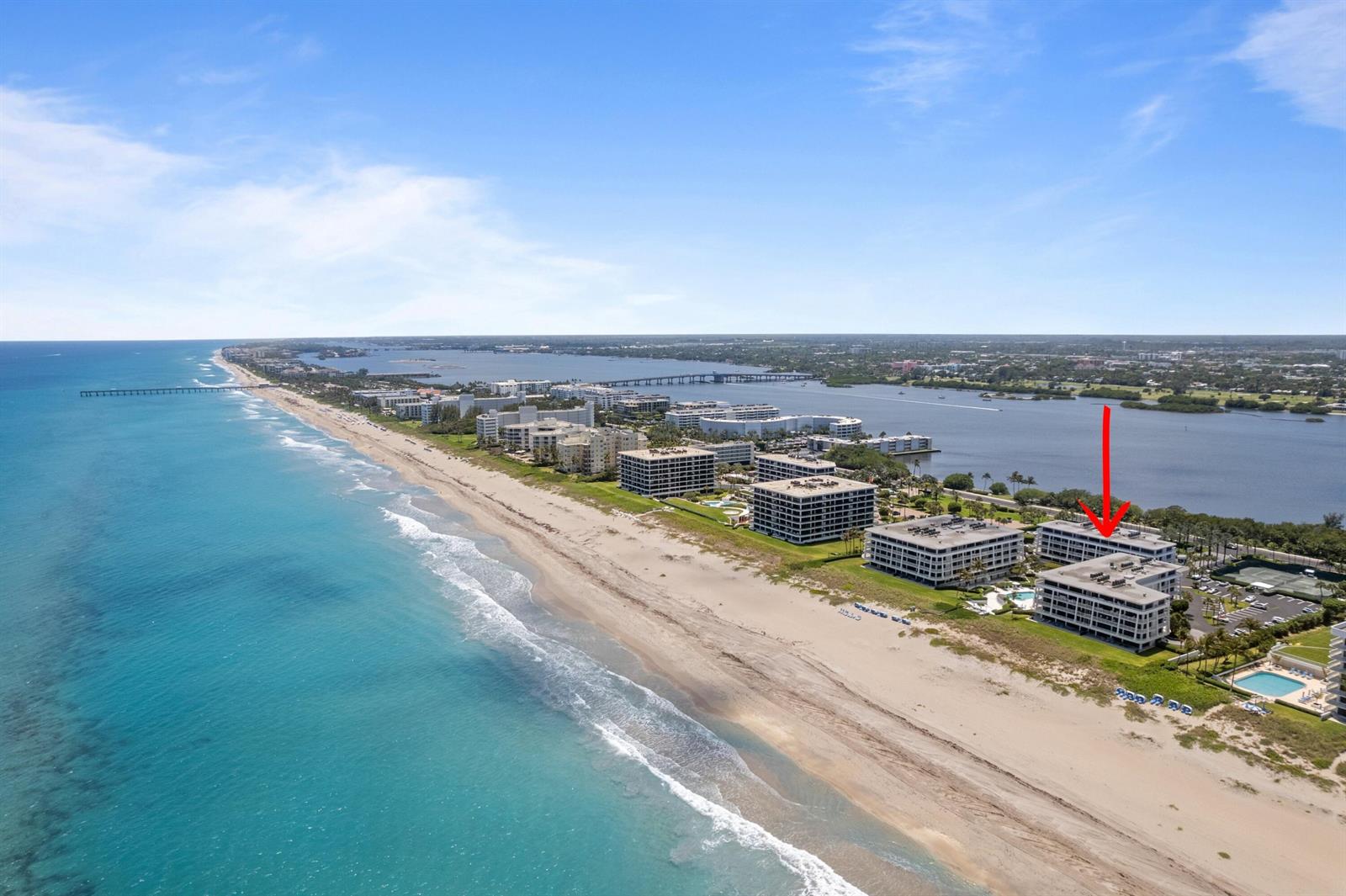 An aerial view of beachfront condominium buildings along the coast with a red arrow pointing down — 2600 S Ocean Boulevard # 202w, Palm Beach FL 33480, PALM BEACH, FL