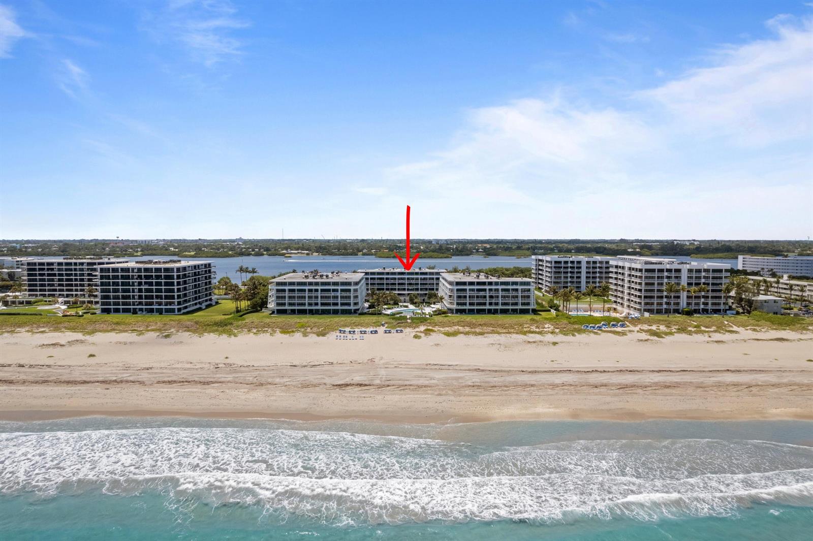 An aerial view shows several beachfront condominium buildings with a red arrow pointing toward one — 2600 S Ocean Boulevard # 202w, Palm Beach FL 33480, PALM BEACH, FL