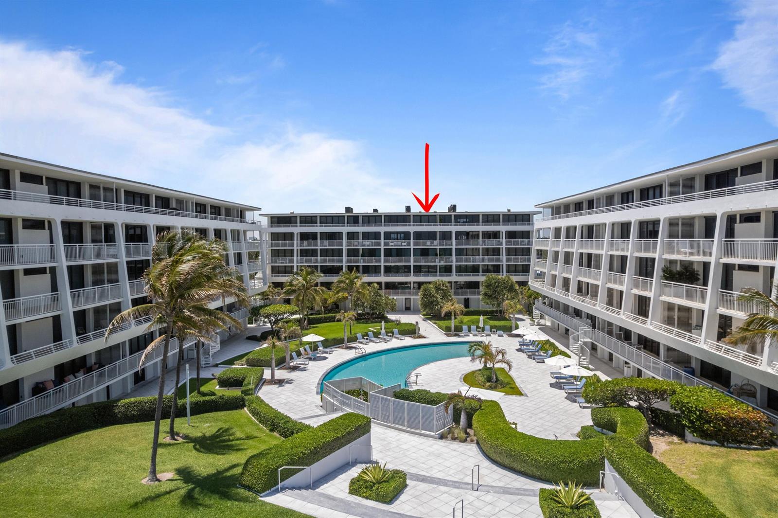 An exterior view of a multi-story apartment complex with a central swimming pool and courtyard — 2600 S Ocean Boulevard # 202w, Palm Beach FL 33480, PALM BEACH, FL