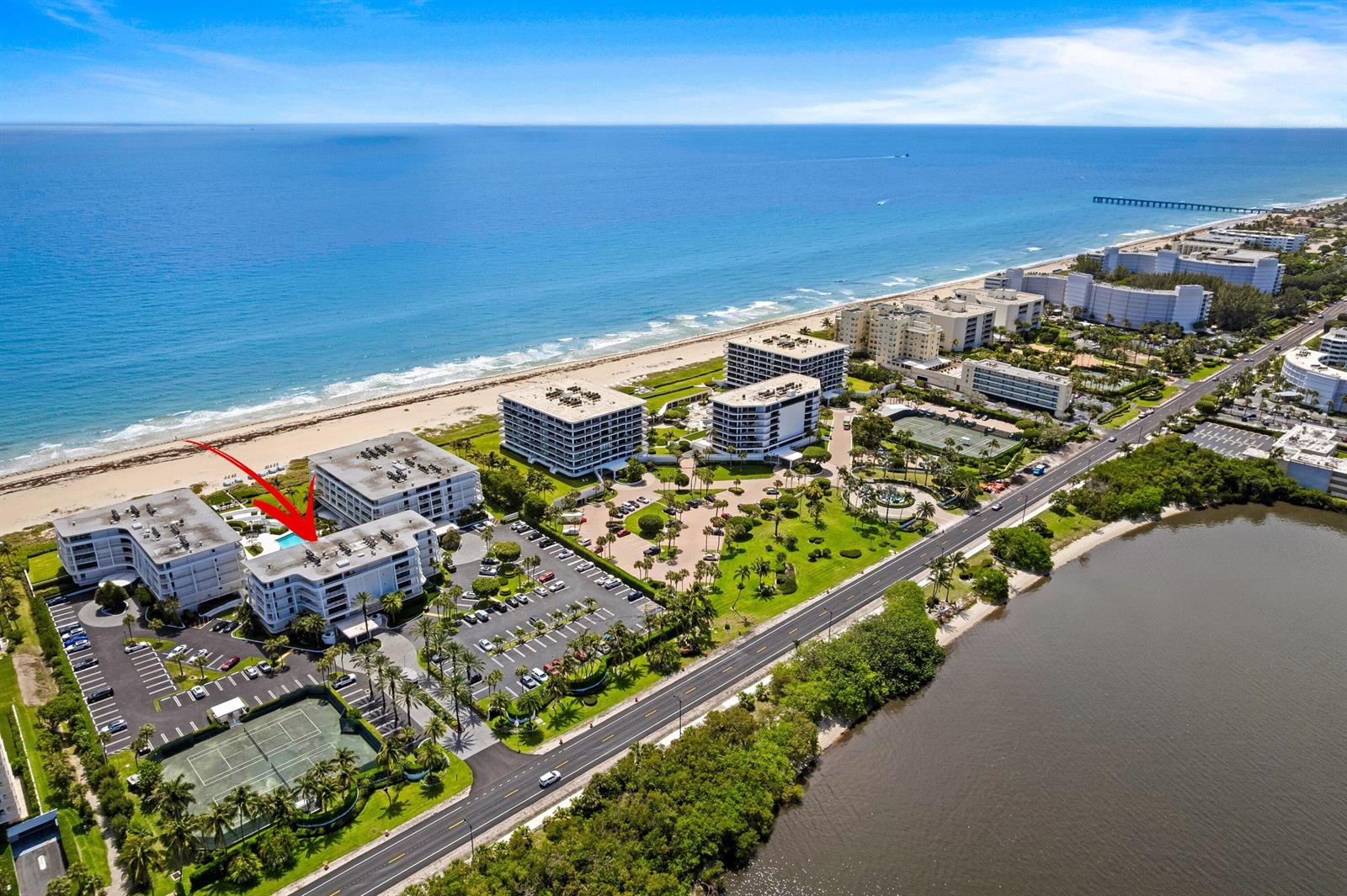 Aerial view of beachfront condominium buildings with a swimming pool and tennis courts — 2600 S Ocean Boulevard # 202w, Palm Beach FL 33480, PALM BEACH, FL