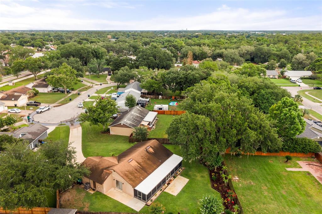 An aerial view shows a suburban house with a brown roof and a screened-in patio — 4608 STURBRIDGE COURT, ORLANDO, FL