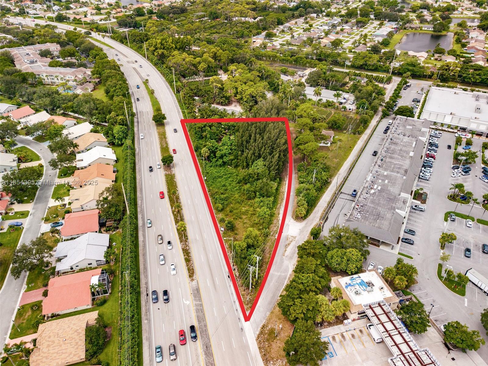An aerial view shows a triangular, undeveloped plot of land bordered by a highway — 8301 S Military Trl, Boynton Beach FL 33436, BOYNTON BEACH, FL