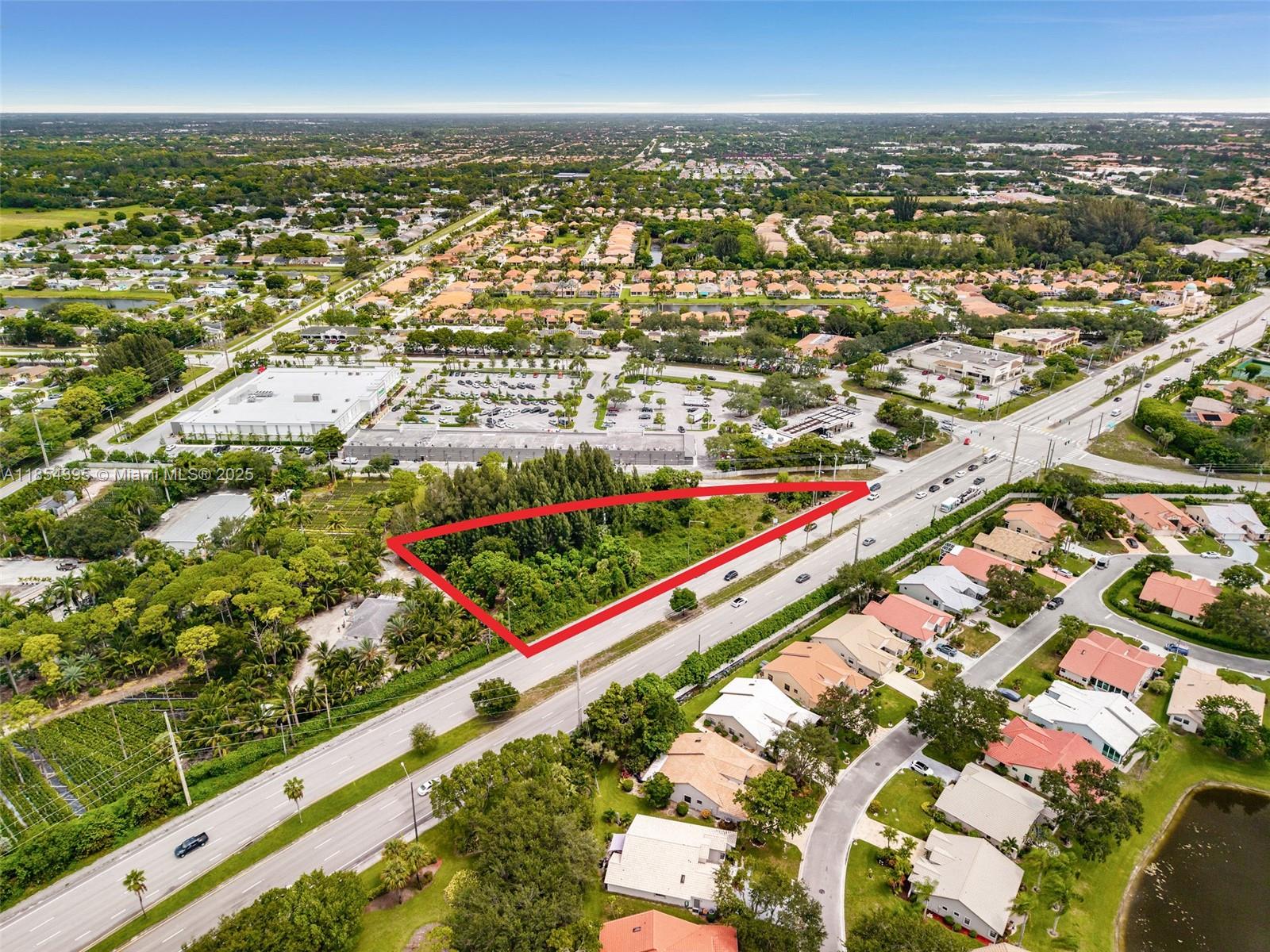 An aerial view shows a triangular, tree-covered vacant lot bordered by a multi-lane road — 8301 S Military Trl, Boynton Beach FL 33436, BOYNTON BEACH, FL