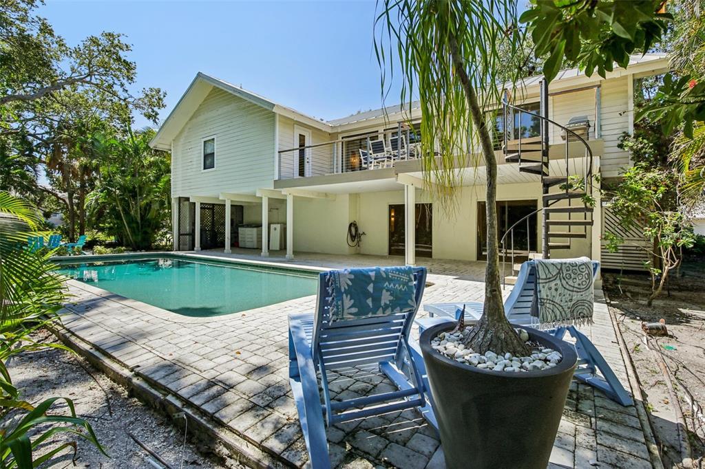 A two-story house with a backyard swimming pool, patio, and a spiral staircase — 3390 BAYOU SOUND, LONGBOAT KEY, FL