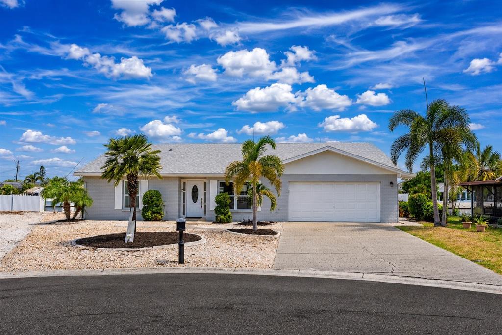 A single-story gray house with a white garage door and two palm trees in front — 805 LEISEY CIRCLE, RUSKIN, FL