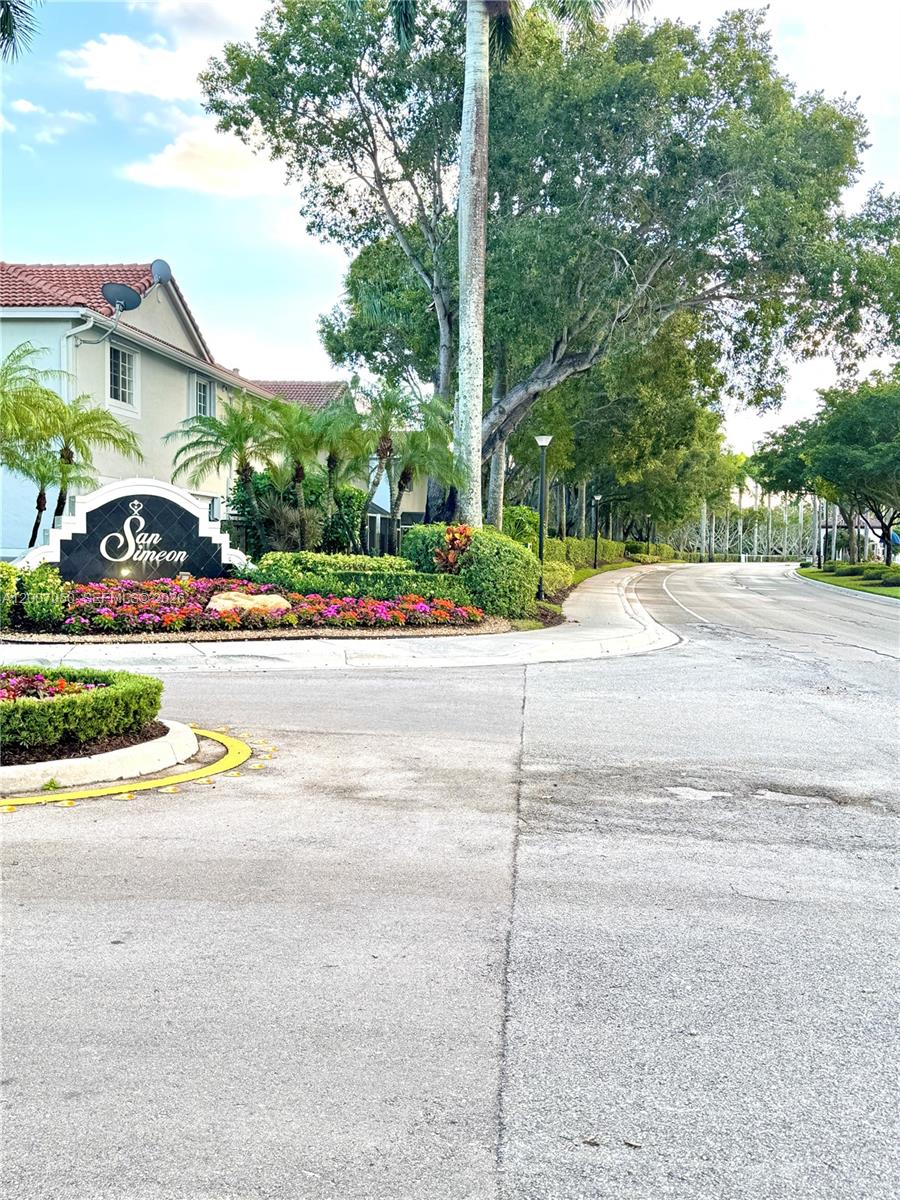 A sign for San Simeon stands at the entrance of a residential community with landscaping — 3742 San Simeon Cir # 3742, Weston FL 33331, WESTON, FL