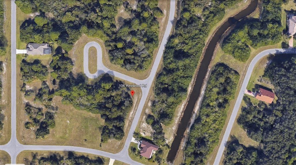 This is an aerial map view of a vacant, wooded residential lot on a cul-de-sac — 106 REDWOOD ROAD, ROTONDA WEST, FL