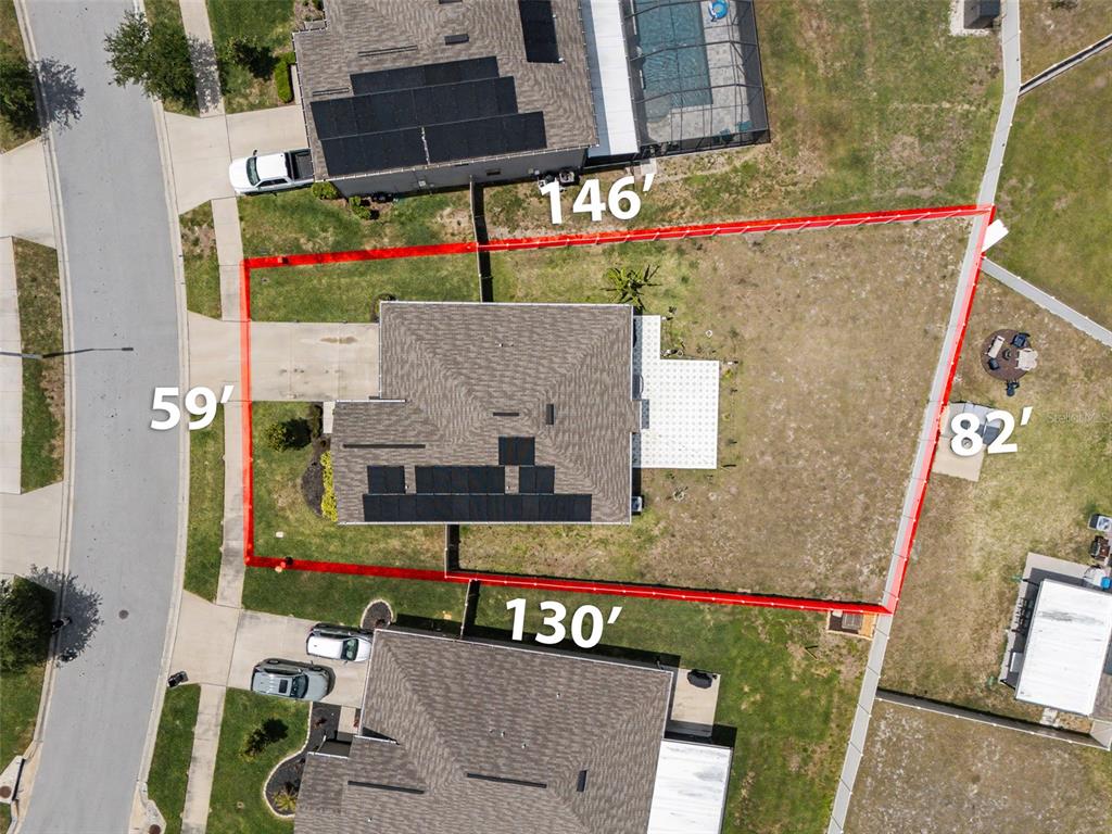This aerial view shows a residential property lot outlined in red with dimensions labeled — 6671 MINERAL SPRINGS ROAD, NEW PORT RICHEY, FL