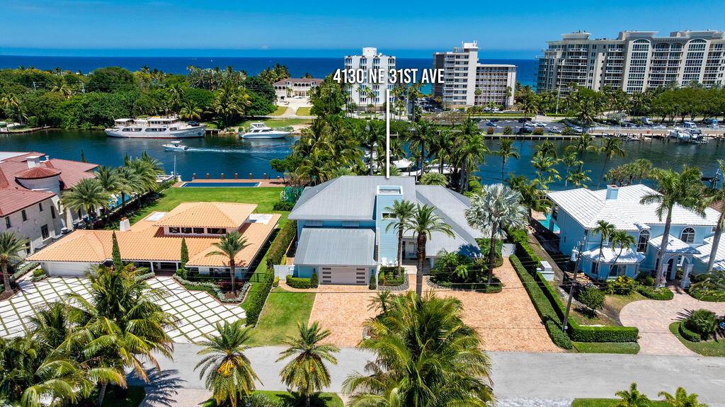 An aerial view shows a light blue waterfront house with a metal roof and pool — 4130 NE 31st Avenue, Lighthouse Point FL 33064, LIGHTHOUSE POINT, FL