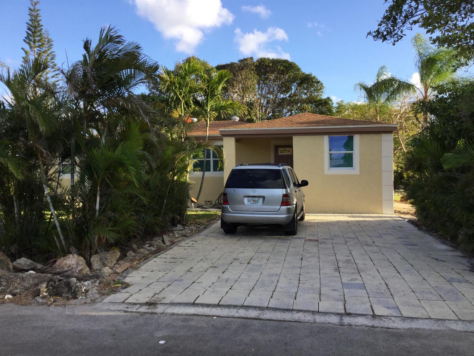 A single-story yellow house with a paved driveway and a parked silver SUV — 130 NW 5th Avenue, Boynton Beach FL 33435, BOYNTON BEACH, FL