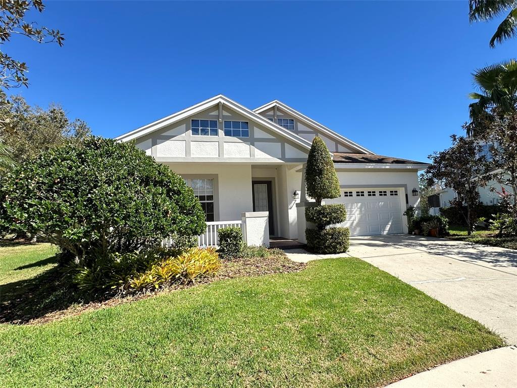 A single-story house with a white exterior, a front porch, and an attached garage — 8120 TURKEY HILL COURT, TAMPA, FL
