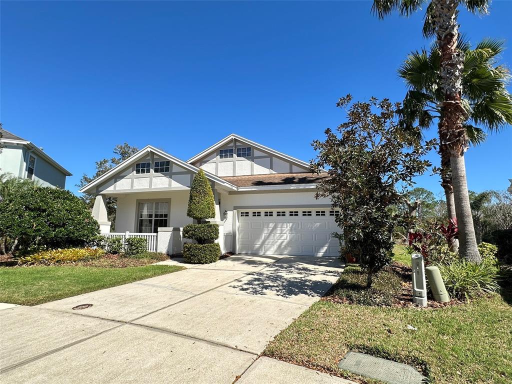 A one-story house with a white exterior, a two-car garage, and a front porch — 8120 TURKEY HILL COURT, TAMPA, FL